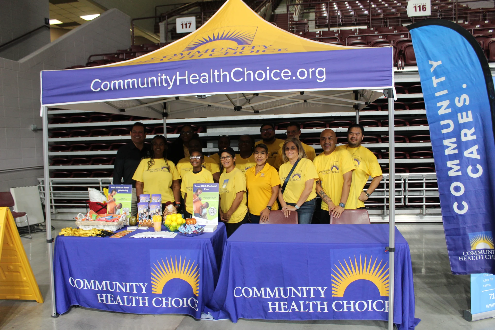 Community Health Choice team standing behind an informational booth with branded table displays at the Equality Health Foundation Houston Fall Festival 2026.